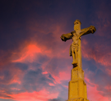 Field Crucifix against the background of the evening sky