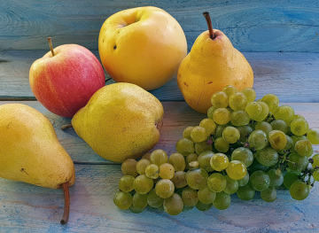 Pears, Apples and Grapes On A Blue Background