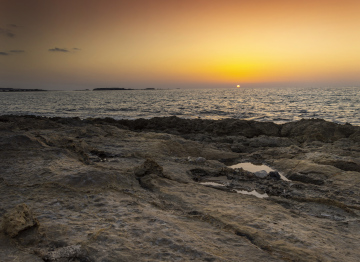 Sunset over the Shore of the Volcanic Rocks