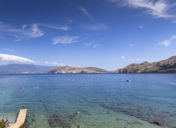 Baska beach and a view of the hills protruding from the sea