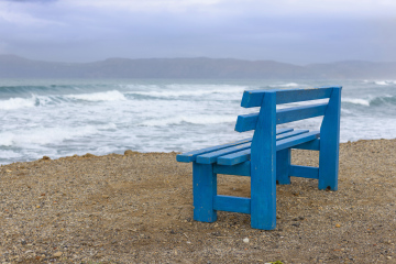 Waves in the Sea and a blue bench