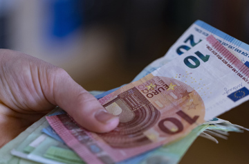 Euro banknotes in a hand
