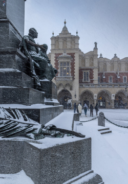 Snowfall in Krakow, fragment of the Adam Mickiewicz monument in the Market Square