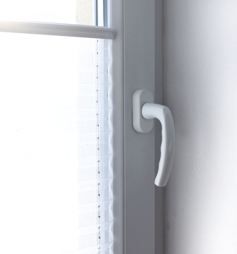 A handle in a white plastic window