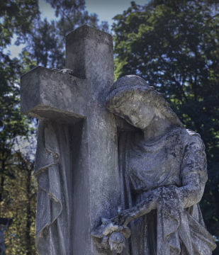 Cemetery statue with a cross