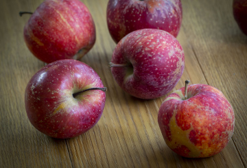 Red Apples on a wooden surface