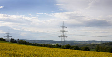 High Voltage Poles In A Suburban Landscape