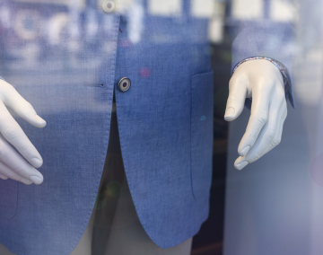 Mannequin in a male wardrobe in a shop window.