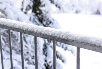 Winter, fresh snow on the balcony railing