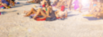 People on a sunny beach, blurred photo.