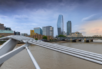 View of the Thames, historic Blackfriars Bridge and modern buildings in London.