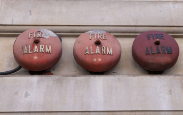 Fire alarm, vintage siren on the wall of the building