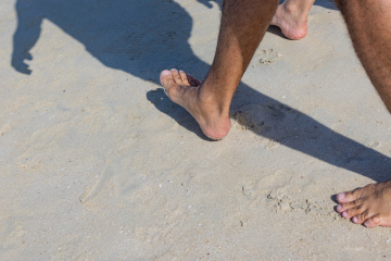 Barefoot on the beach. Walk on sand.
