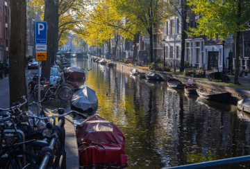 Canal in Amsterdam and boats covered with tarpaulins