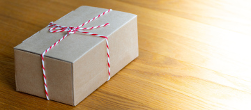 A gift in a cardboard box tied with a string