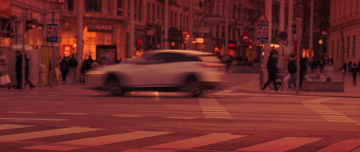 Speeding car, city traffic, red glow