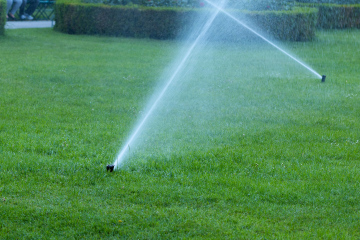 Watering in the City Park. Sprinklers on the lawn.