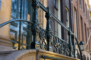 Steel balustrade in front of the facade of a historic building, stock photo