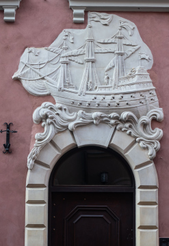 Relief. A tenement house under a ship in Warsaw.