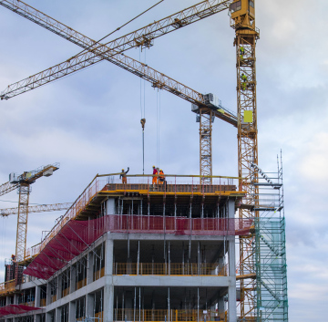 Construction cranes during the erection of building walls