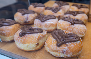 Donuts filled with filling and decorated with chocolate hearts