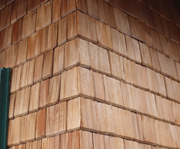 The facade of the building is covered with wooden shingles