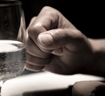 Hand and a Glass of Water