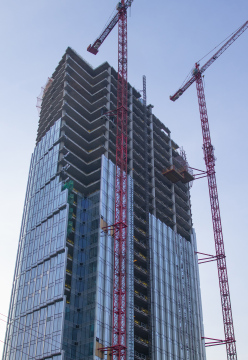 Construction of a skyscraper with a glass facade