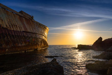 Edro III shipwreck at the rocky shore at sunset, Cyprus