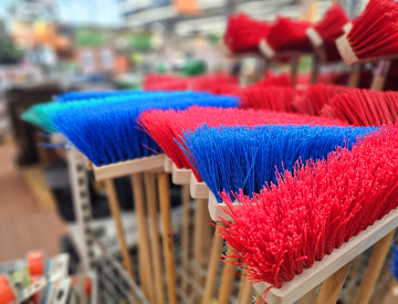 Sale of colorful brushes and brooms in the store