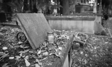 A candle on a historic grave, black and white photo