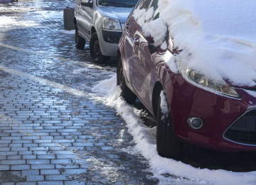 Snow on parked cars, snow on the sidewalk