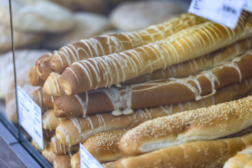 Bread on sale. Long rolls with melted cheese and sprinkled with sesame seeds.