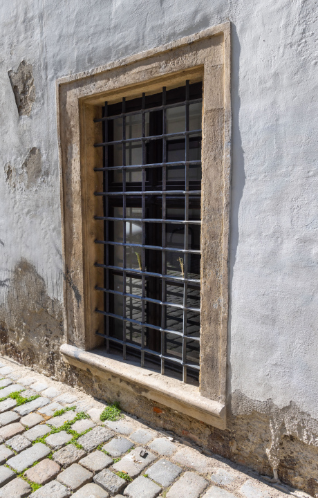 Barred Window in the facade of a historic building