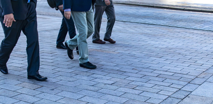 Men in suits on the sidewalk