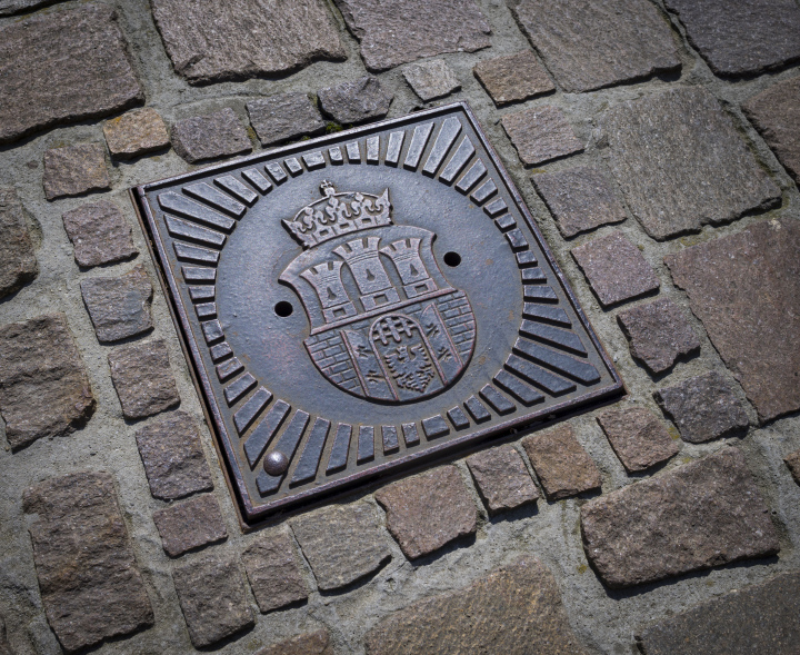 Water supply manhole cover with the coat of arms of Krakow