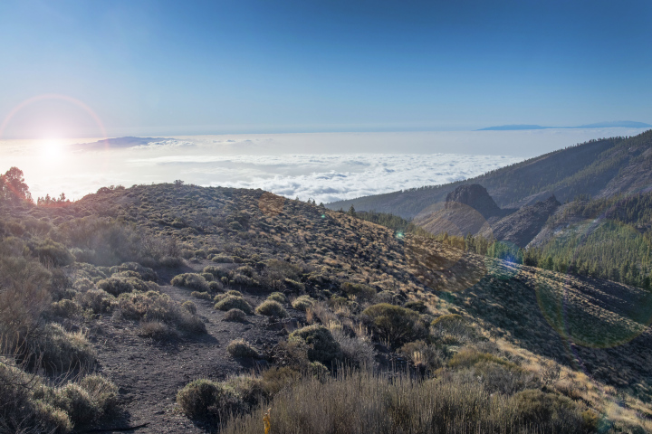 A valley with rocks and a view of the clouds and the south of Tenerife