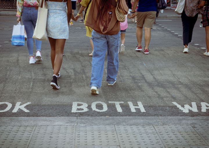 People at the pedestrian crossing, sidewalk.