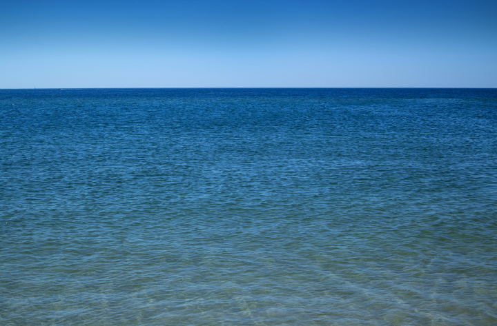 A vast ocean with a calm water surface