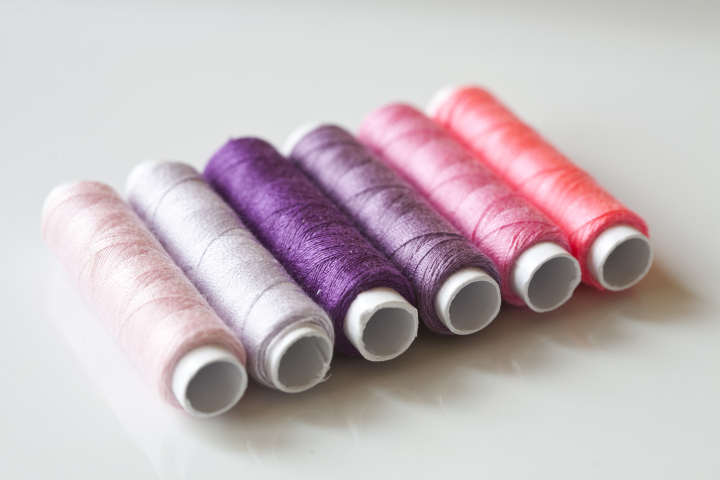 A set of pink and violet threads