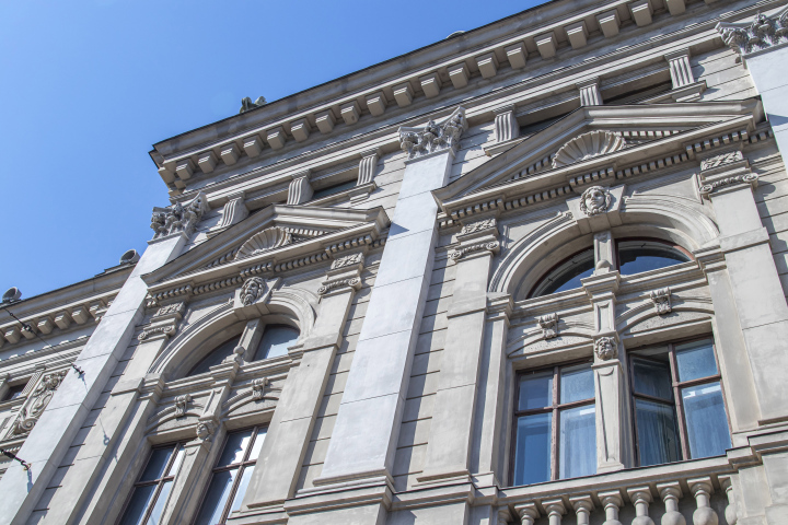 The facade of a historic tenement house with architectural details