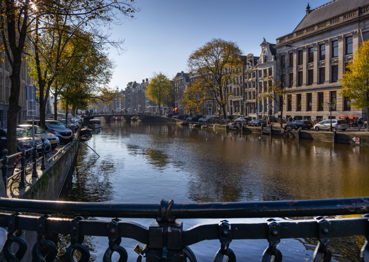 A canal in Amsterdam and a fragment of a bridge railing