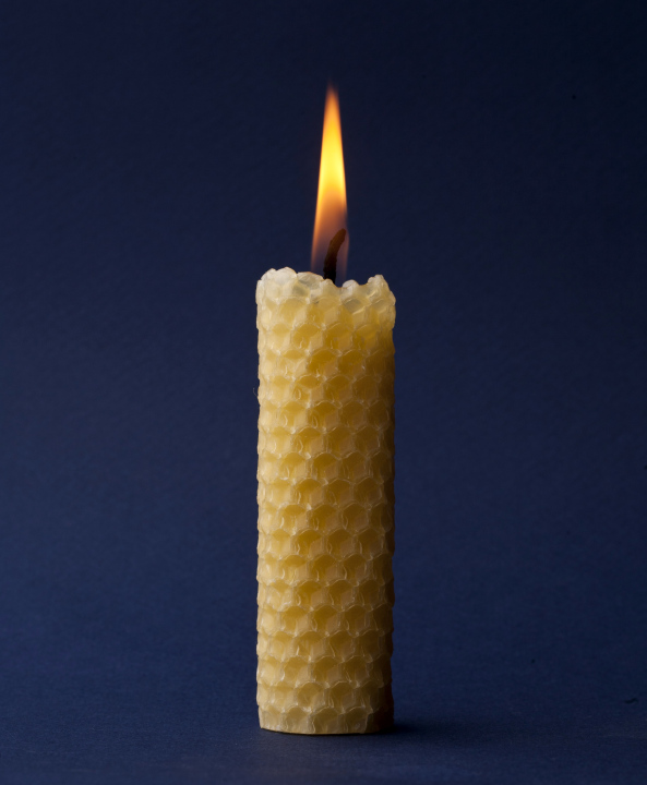 Wax candle on a dark blue background
