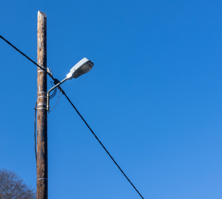 Wooden pole with street lighting