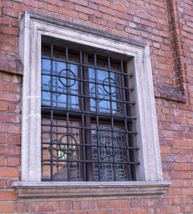 An antique window with a grill