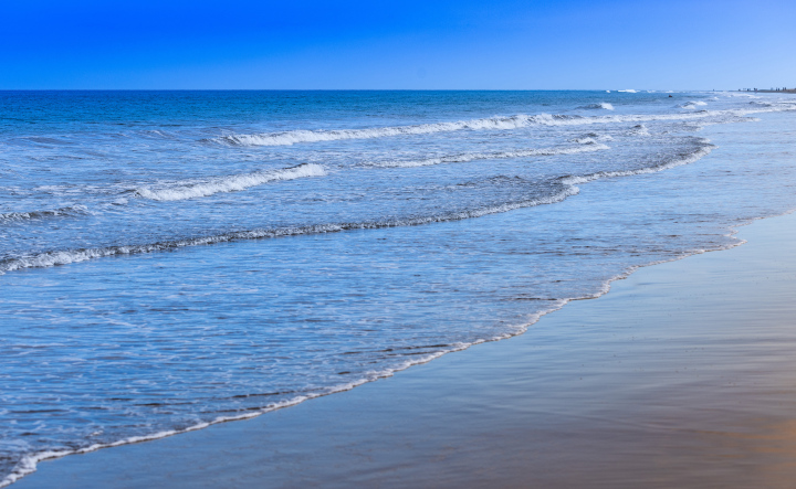 Sea and gentle waves by the beach.