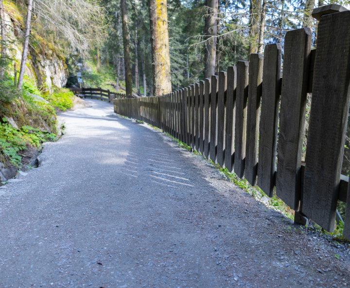 A wooden fence by a mountain trail